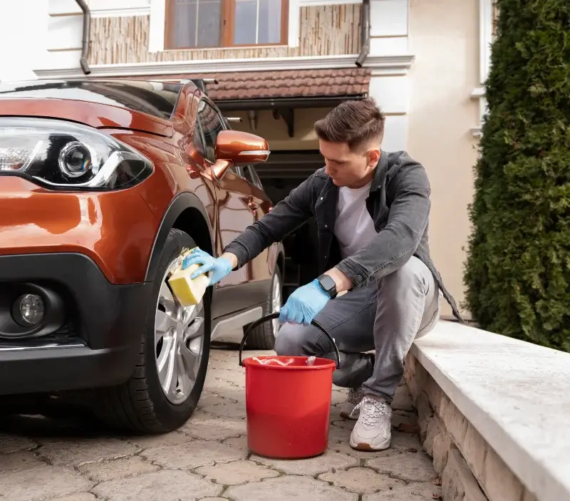 Lavage auto à domicile Hérouville-en-Vexin : professionnel intervenant sur un véhicule